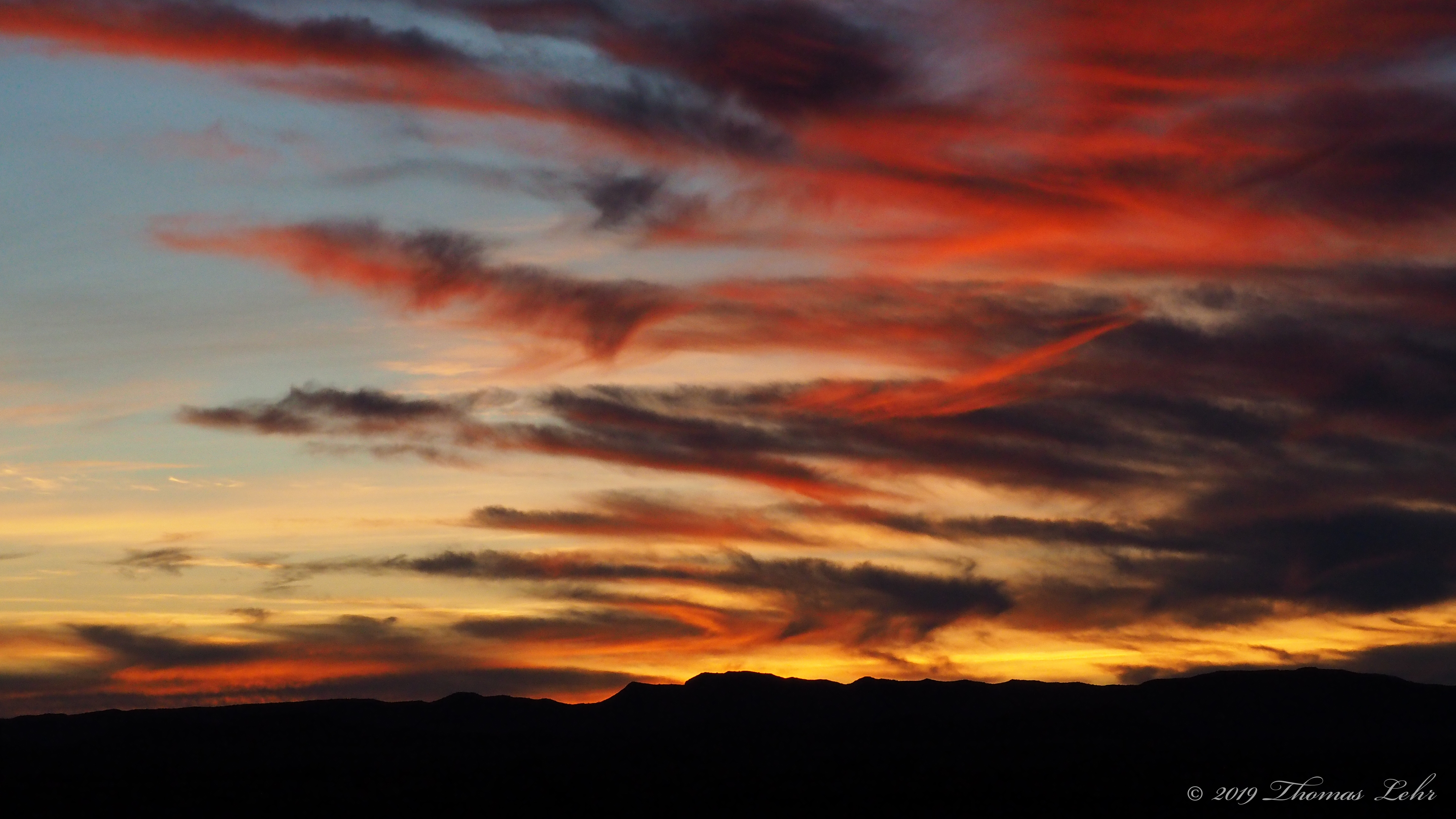 … Nights expanding into / enormous parachutes of fire, his