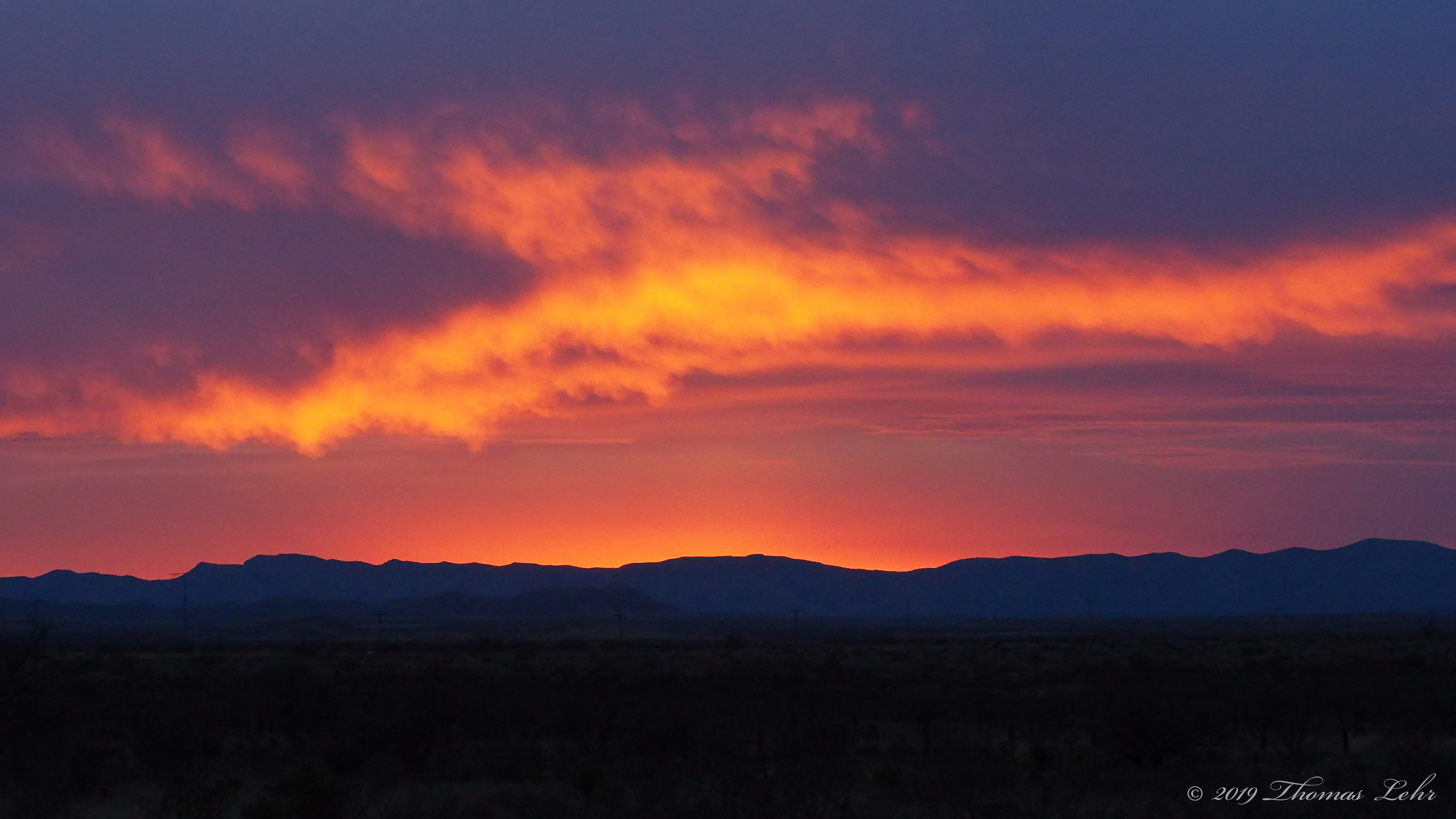 as one turns a mirror to flash the light to where