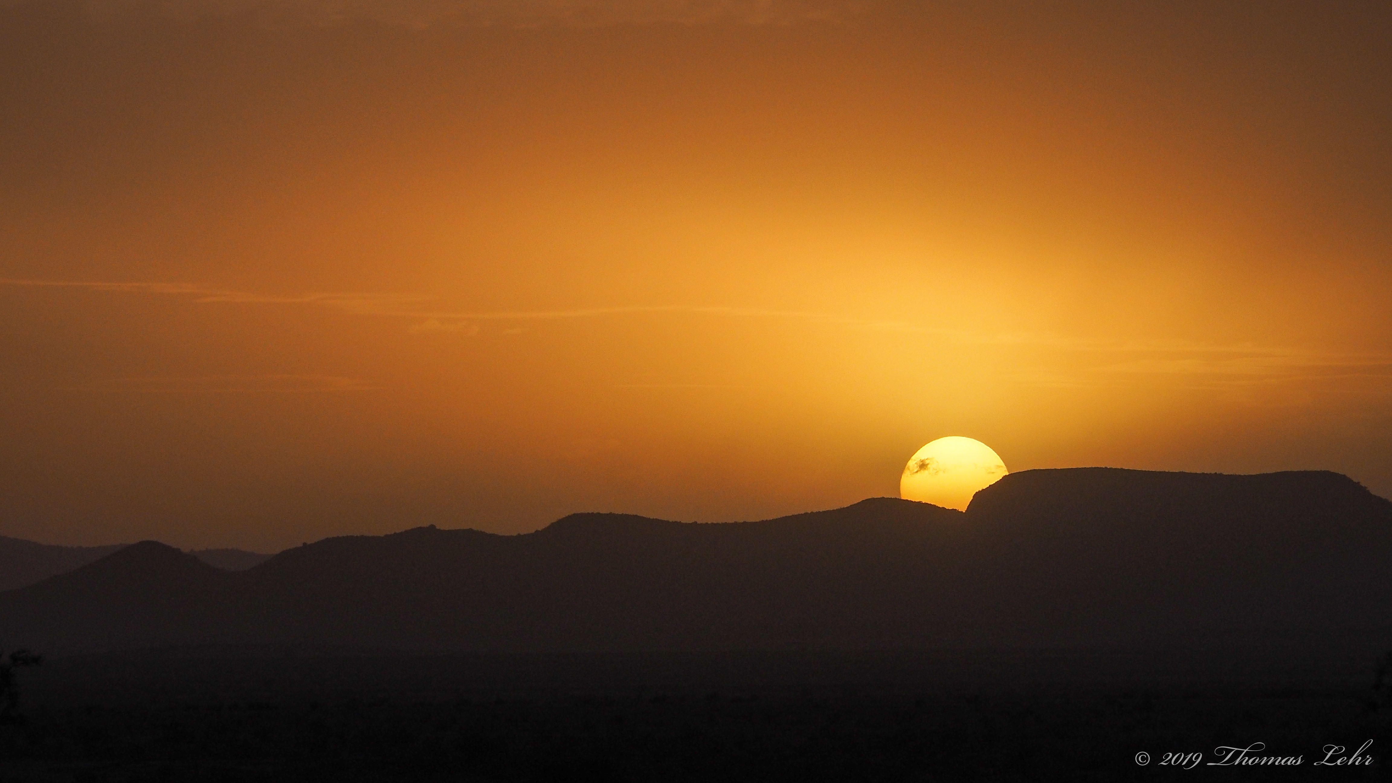 And the sun shining down like God, loving all of us equally,