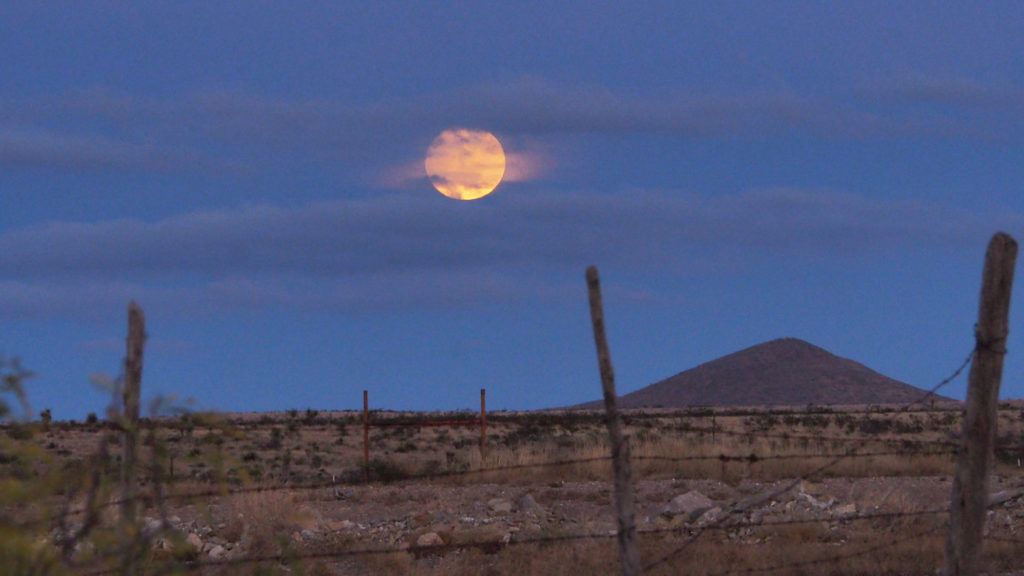 of rock, the moon huge and unouched
