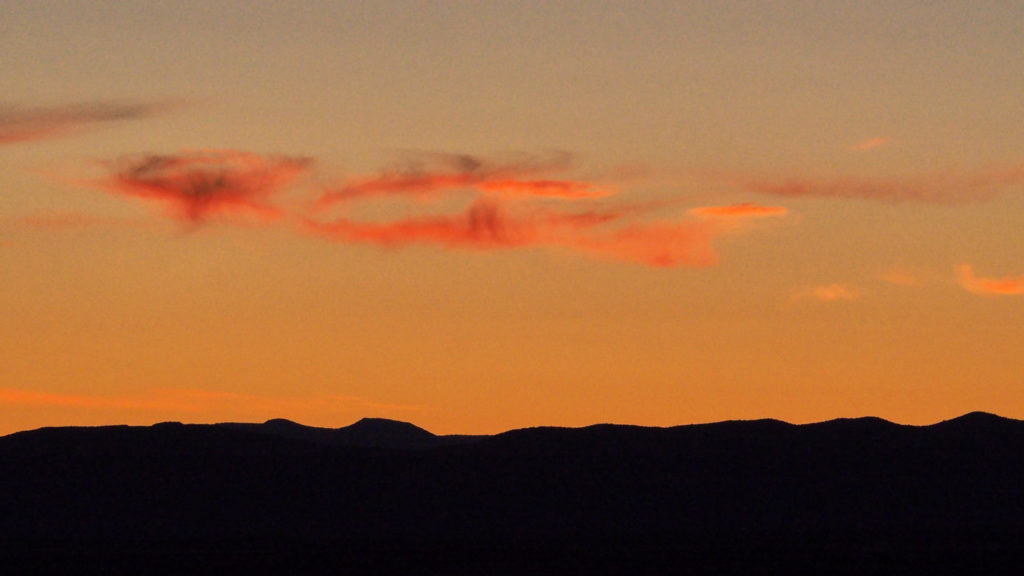 and hides without hiding behind an unminding cloud.