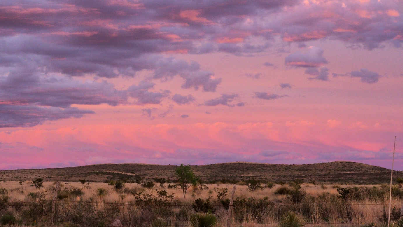 With her clothes undulating into a thousand colors,